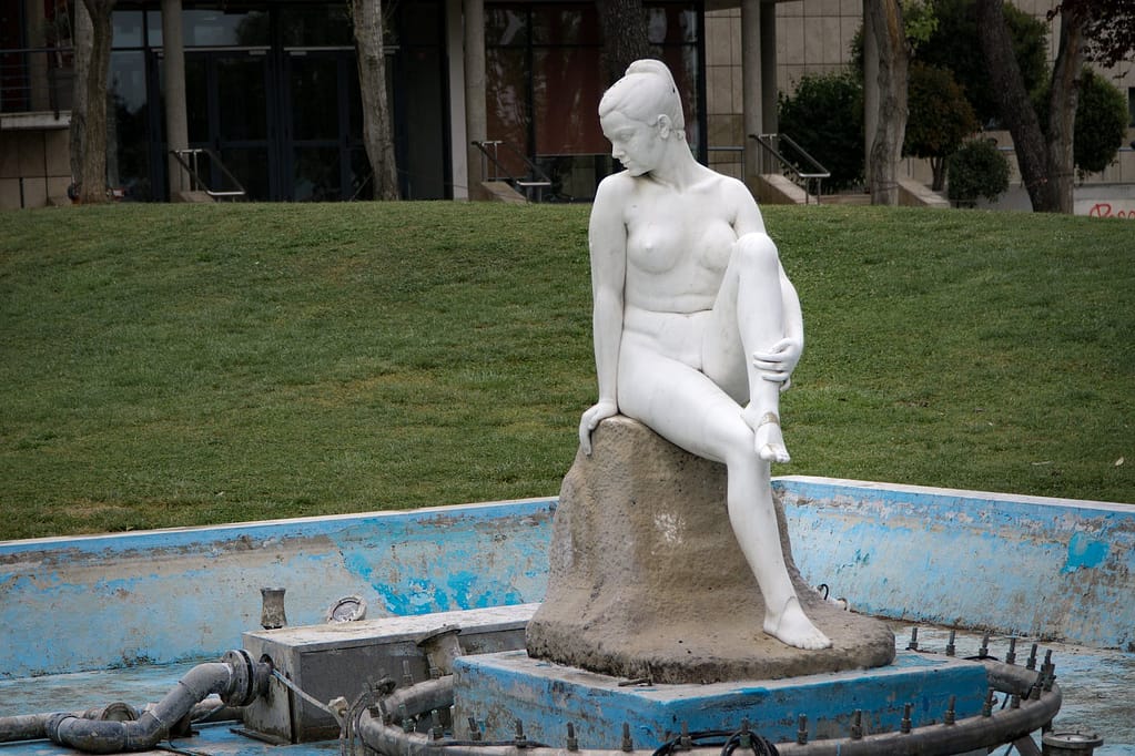 naked woman white concrete statue near green grass nude news indie birds