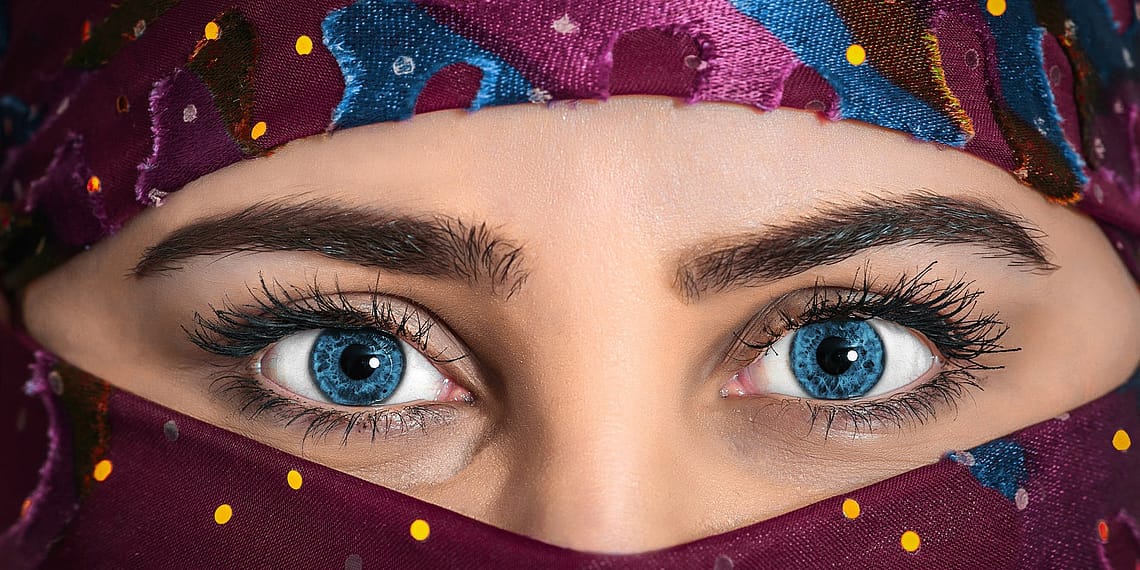 woman with blue eyes wearing purple hijab scarf