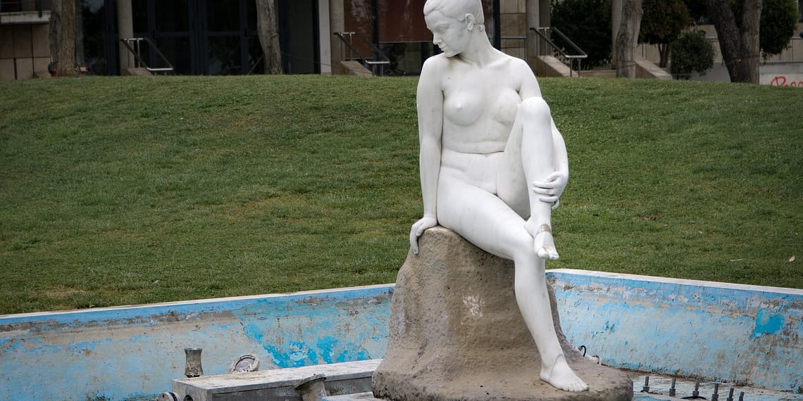 naked woman white concrete statue near green grass nude news indie birds